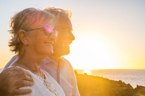 Picture of older couple embracing and enjoying the sunset