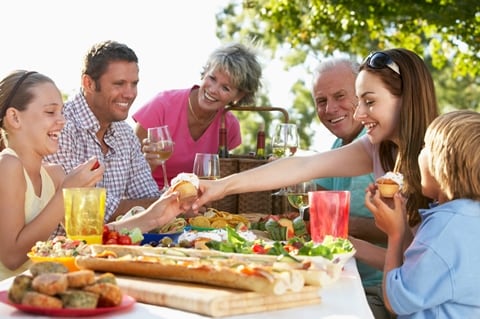 family_time_1 Picture of family gathered round outdoor dining table at Treghan Luxury Lodge