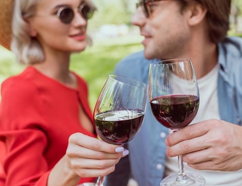 Image of a man and women enjoying a glass of red wine