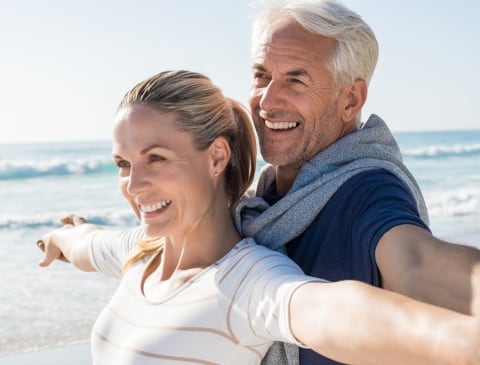 Picture of older couple at the beach in the sun