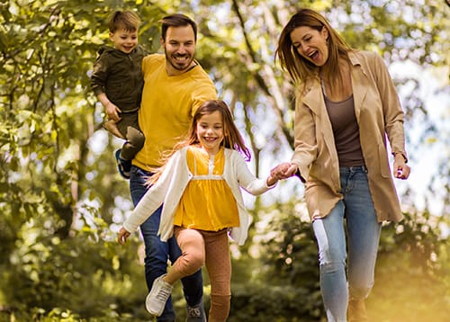 We always enjoy family bonding time. We always enjoy family bonding time. Parents spending time with their children outside. Focus is on foreground.