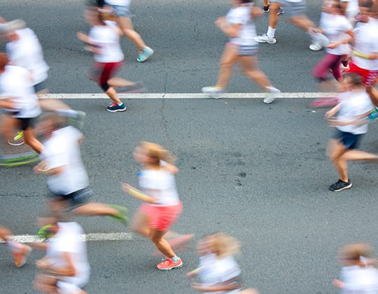 Half marathon on city streets Picture of family gathered round outdoor dining table at Treghan Luxury Lodge