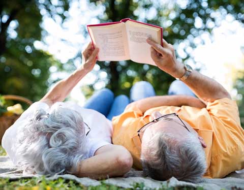 Couple reading under the trees