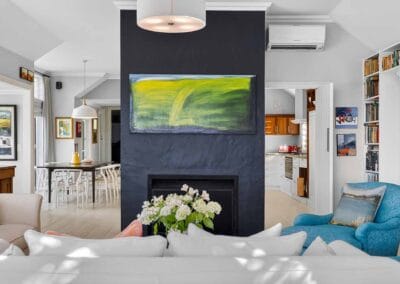 Treghan inside living area looking past fireplace to dining and kitchen