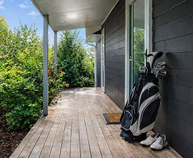 Golf clubs on the private deck of a luxury guesthouse at Treghan Lodge in Kerikeri, Bay of Islands, ideal for relaxed New Zealand golf escapes Golf clubs on the private deck of a luxury guesthouse at Treghan Lodge in Kerikeri, Bay of Islands, ideal for relaxed New Zealand golf escapes