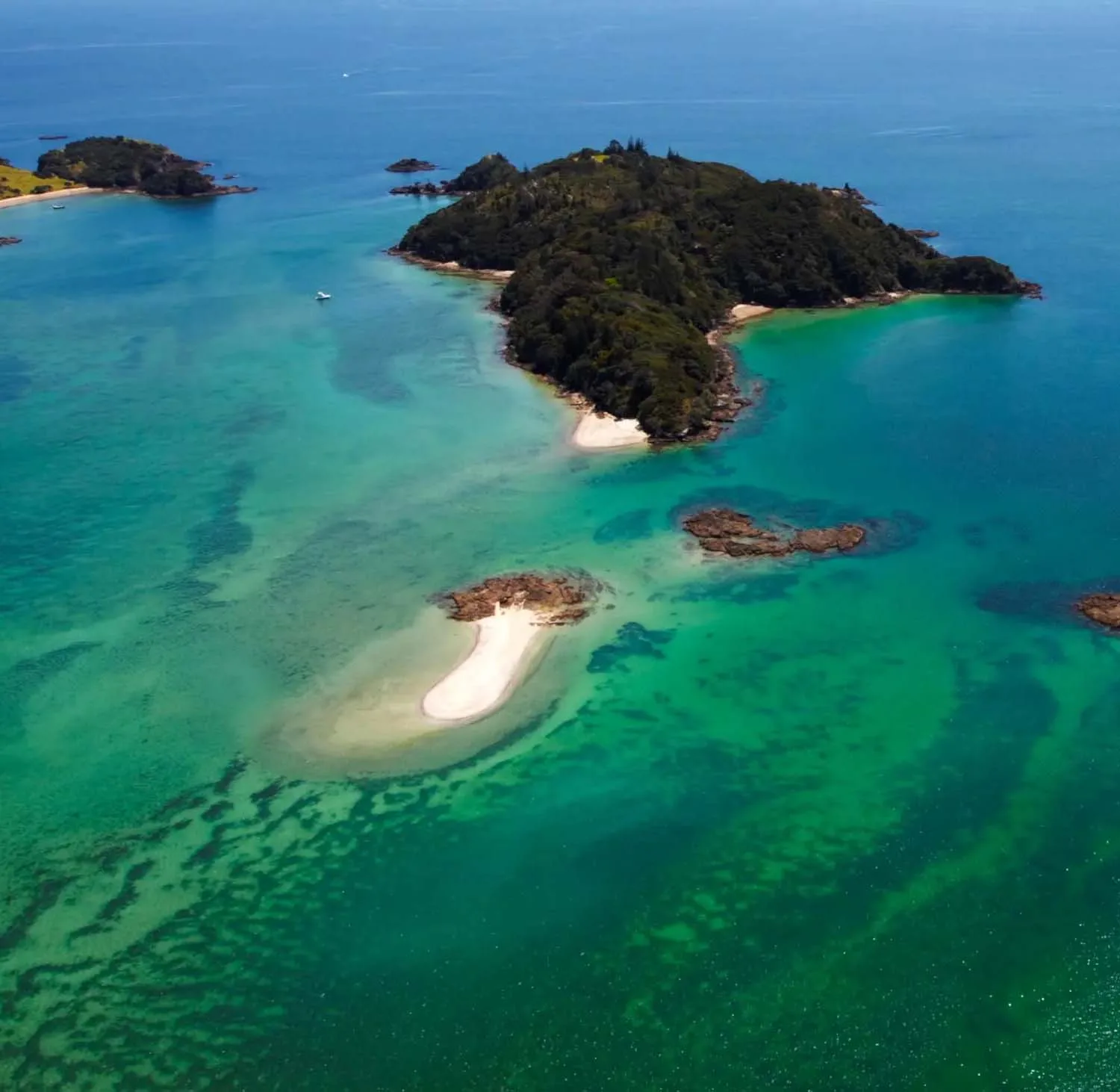 Aerial view of the Bay of Islands showcasing turquoise waters, islands and coastline in Northland, New Zealand Aerial view of the Bay of Islands showcasing turquoise waters, islands and coastline in Northland, New Zealand