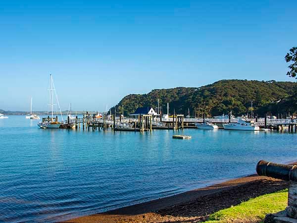 Russell Wharf overlooking the Bay of Islands with boats moored in the harbour, Northland, New Zealand. Russell Wharf overlooking the Bay of Islands with boats moored in the harbour, Northland, New Zealand.