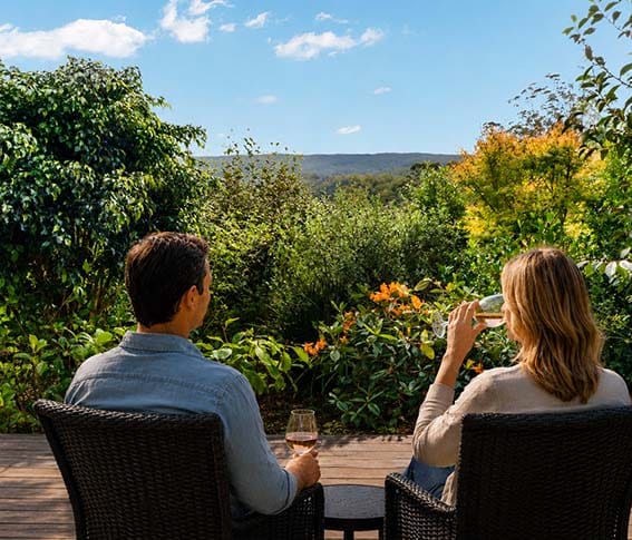 Couple relaxing on the deck of a private luxury guesthouse in Kerikeri, an ideal base for exploring the Bay of Islands and Far North. Couple relaxing on the deck of a private luxury guesthouse in Kerikeri, an ideal base for exploring the Bay of Islands and Far North.