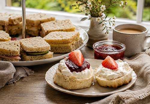 Afternoon tea with homemade scones, finger sandwiches and freshly brewed tea at Treghan Lodge in Kerikeri, Bay of Islands.